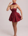 Structured mini dress with fitted bodice and sculptural volume at hips