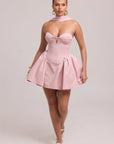 Structured mini dress with fitted bodice and sculptural volume at hips
