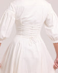 backview of laced up white shirt dress