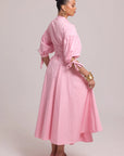 pink shirt dress with shaped seams, full skirt, and lace-up back