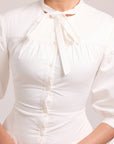 White structured shirt dress with full skirt and adjustable lace-up back