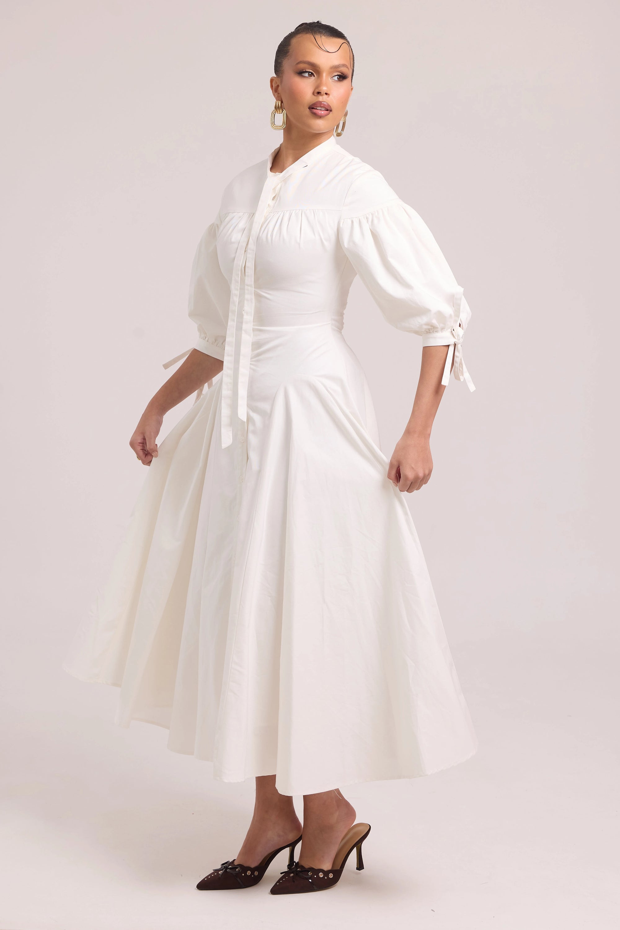 White cotton dress with lace-up back and curved waist cut-out
