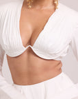 Crop top with pleated detailing paired with a voluminous skirt