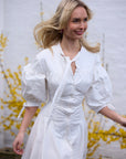 White button-down shirt dress with voluminous sleeves and fitted waist