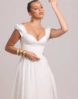 White cotton dress highlighting curved waist cut-out